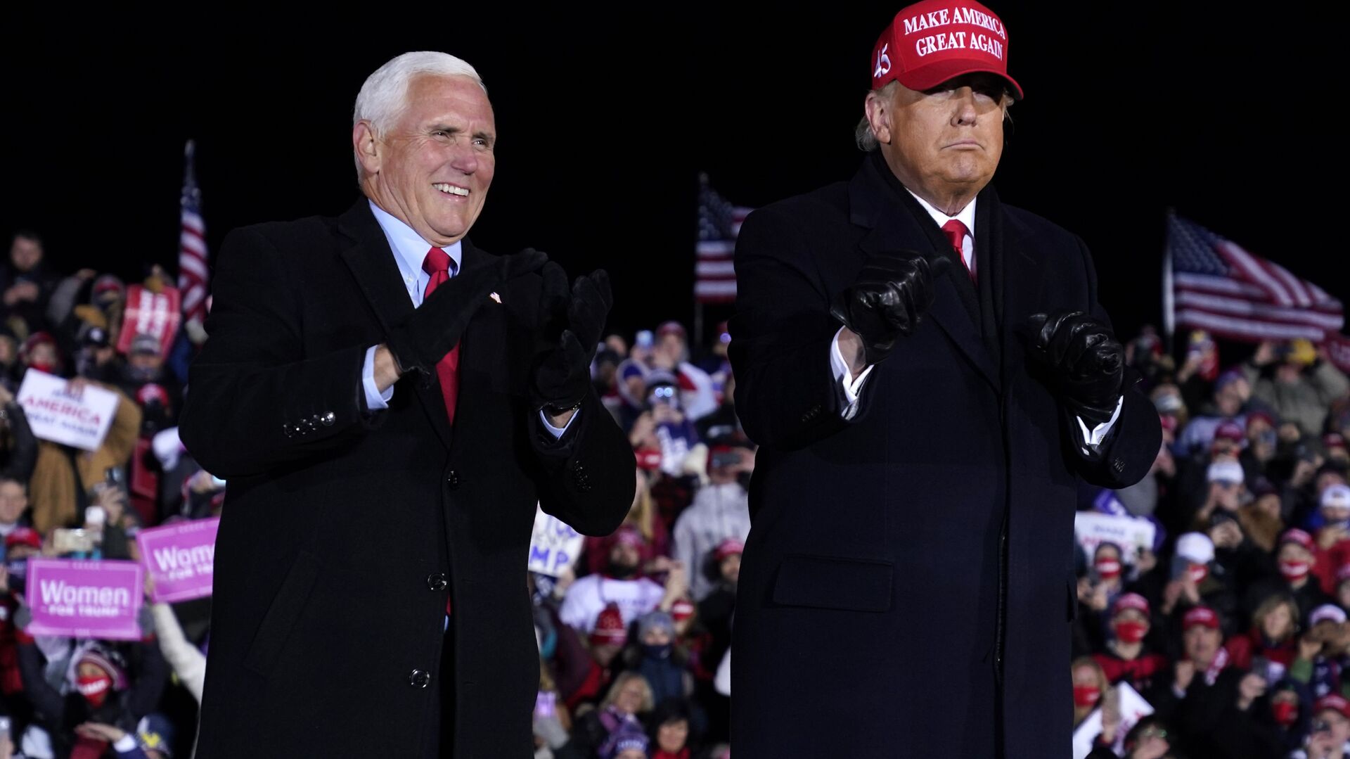 President Donald Trump and Vice President Mike Pence smile after a campaign rally at Gerald R. Ford International Airport, early Tuesday, Nov. 3, 2020, in Grand Rapids, Mich - Sputnik International, 1920, 01.02.2022