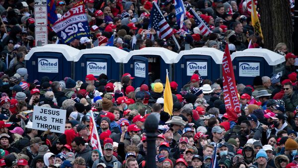 People wait on the National Mall outside a security perimeter for a rally of supporters of US President Donald Trump challenging the results of the 2020 US Presidential election on the Ellipse on January 6, 2021 in Washington, DC.  - Sputnik International