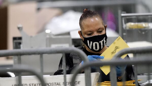 An official counts ballots for Georgia's Senate runoff election at the Georgia World Congress Center on Wednesday, Jan. 6, 2021, in Atlanta.  - Sputnik International
