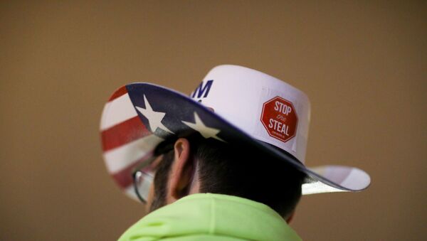 A supporter of U.S. President Donald Trump wearing a hat with a sticker on it reading Stop the Steal attends a rally ahead of the U.S. Congress certification of the November 2020 election results, during protests in Washington, U.S., January 5, 2021. - Sputnik International
