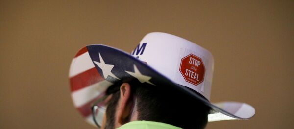 A supporter of U.S. President Donald Trump wearing a hat with a sticker on it reading Stop the Steal attends a rally ahead of the U.S. Congress certification of the November 2020 election results, during protests in Washington, U.S., January 5, 2021. - Sputnik International