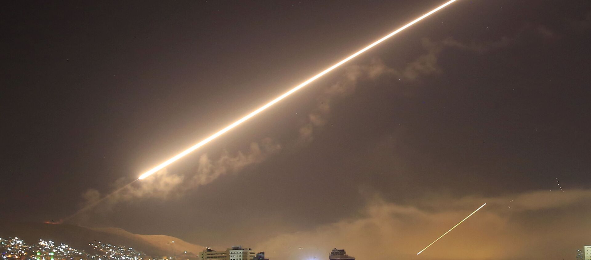 In this April 14, 2018 file photo, Damascus skies erupt with surface to air missile fire as the U.S. launches an attack on Syria targeting different parts of the Syrian capital Damascus, Syria. - Sputnik International, 1920, 25.02.2021