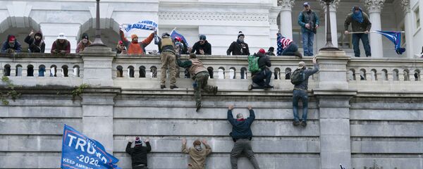 Supporters of President Donald Trump climb the west wall of the the U.S. Capitol on Wednesday, Jan. 6, 2021, in Washington. (AP Photo/Jose Luis Magana) Supporters of President Donald Trump climb the west wall of the the U.S. Capitol on Wednesday, Jan. 6, 2021, in Washington. (AP Photo/Jose Luis Magana) - Sputnik International