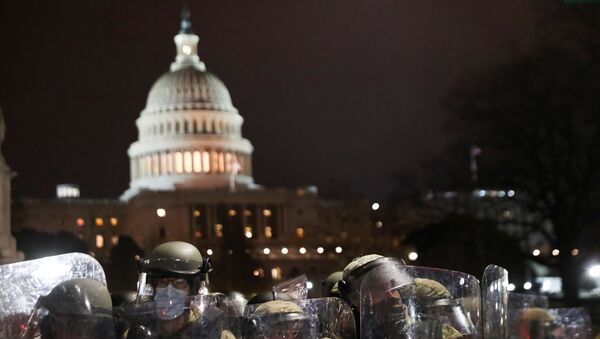 Members of the National Guard stand guard as supporters of U.S. President Donald Trump gather outside the U.S. Capitol building during a protest against the certification of the 2020 U.S. presidential election results by the U.S. Congress, in Washington, U.S., January 6, 2021. - Sputnik International