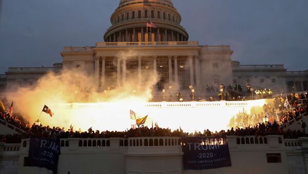 An explosion caused by a police munition is seen while supporters of U.S. President Donald Trump gather in front of the U.S. Capitol Building in Washington, U.S., January 6, 2021. - Sputnik International