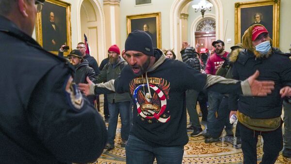 Trump supporters gesture to U.S. Capitol Police in the hallway outside of the Senate chamber at the Capitol in Washington, Wednesday, Jan. 6, 2021. (AP Photo/Manuel Balce Ceneta) - Sputnik International