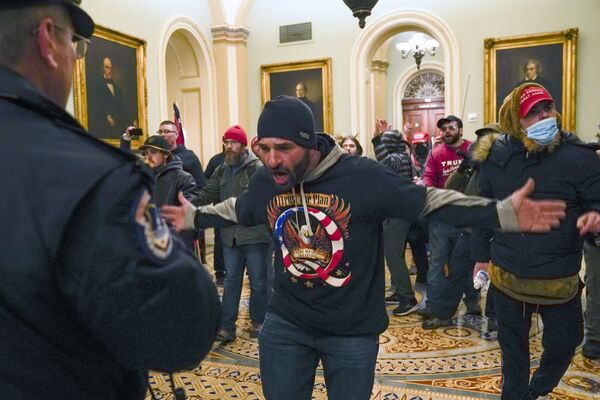 Trump supporters gesture to US Capitol Police in the hallway outside of the Senate chamber at the Capitol in Washington, Wednesday, 6 January 2021 - Sputnik International