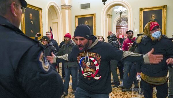 Trump supporters gesture to US Capitol Police in the hallway outside of the Senate chamber at the Capitol in Washington, Wednesday, Jan. 6, 2021 - Sputnik International