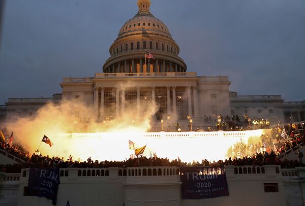 An explosion caused by a police munition is seen while supporters of US President Donald Trump gather in front of the US Capitol Building in Washington, US, 6 January 2021 - Sputnik International