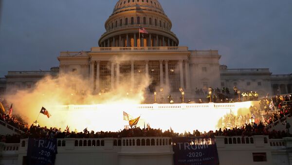 An explosion caused by a police munition is seen while supporters of US President Donald Trump gather in front of the US Capitol Building in Washington, US, January 6, 2021 - Sputnik International