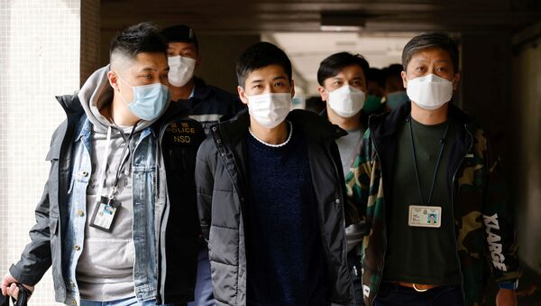 Pro-democracy activist Lester Shum is taken away by police officers after over 50 Hong Kong activists arrested under security law as crackdown intensifies, in Hong Kong, China January 6, 2021.  - Sputnik International