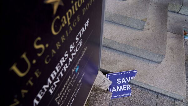 Scraps of a demonstrator's poster lays below a Congressional members and staff entrance sign at the Senate Carriage Entrance of the U.S. Capitol a day after hundreds of supporters of U.S. President Donald Trump occupied the Capitol in Washington, U.S., January 7, 2021. - Sputnik International