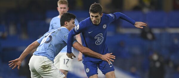 Manchester City's Rodrigo, left, challenges Chelsea's Christian Pulisic during the English Premier League soccer match between Chelsea and Manchester City at Stamford Bridge, London, England, Sunday, Jan. 3, 2021. Manchester City's Rodrigo, left, challenges Chelsea's Christian Pulisic during the English Premier League soccer match between Chelsea and Manchester City at Stamford Bridge, London, England, Sunday, Jan. 3, 2021. - Sputnik International