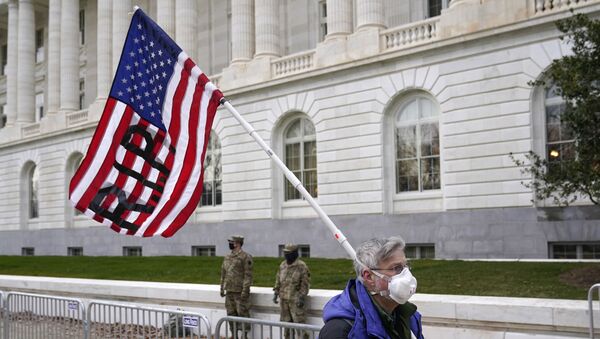 A protester walks past the Russell Senate Office Building on Capitol Hill in Washington, Friday, Jan. 8, 2021. - Sputnik International
