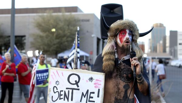 A Qanon believer speaks to a crowd of President Donald Trump supporters outside of the Maricopa County Recorder's Office where votes in the general election are being counted, in Phoenix, Thursday, Nov. 5, 2020. - Sputnik International