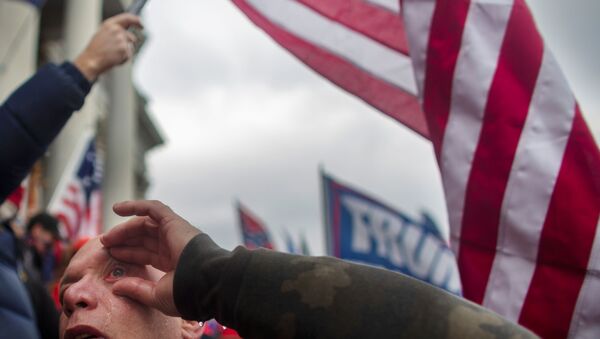 A pro-Trump protester washes his eye during a rally to contest the certification of the 2020 U.S. presidential election results by the U.S. Congress, at the U.S. Capitol Building in Washington, D.C - Sputnik International