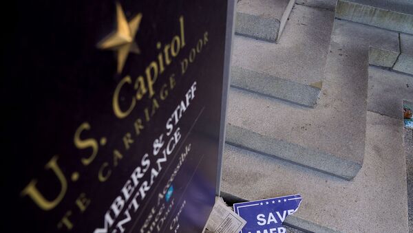 Scraps of a demonstrator's poster lays below a Congressional members and staff entrance sign at the Senate Carriage Entrance of the U.S. Capitol a day after hundreds of supporters of U.S. President Donald Trump occupied the Capitol in Washington - Sputnik International