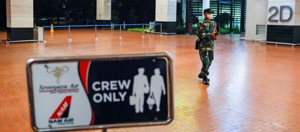 An Indonesian soldier walks at Soekarno-Hatta International Airport after Sriwijaya Air plane flight SJ182 with more than 50 people on board lost contact after taking off, according to local media, in Tangerang, near Jakarta, Indonesia, January 9, 2021. - Sputnik International