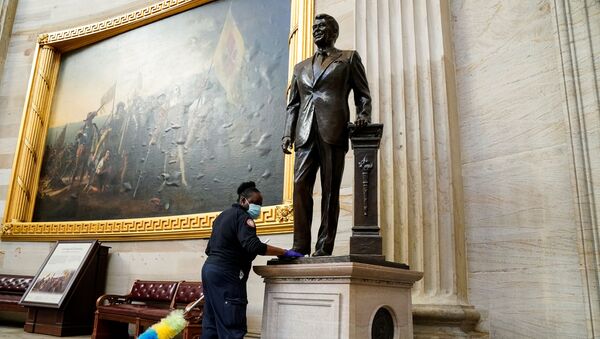 A worker cleans a statue of former President Ronald Reagan inside the Rotunda of the U.S. Capitol a day after supporters of U.S. President Donald Trump stormed the Capitol in Washington, U.S., January 7, 2021. - Sputnik International