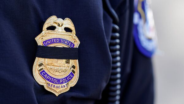 A Capitol Hill police officer wears a black band over his badge in honor of the police officer who died after supporters of U.S. President Donald Trump stormed the U.S. Capitol in Washington, U.S., January 10, 2021. - Sputnik International