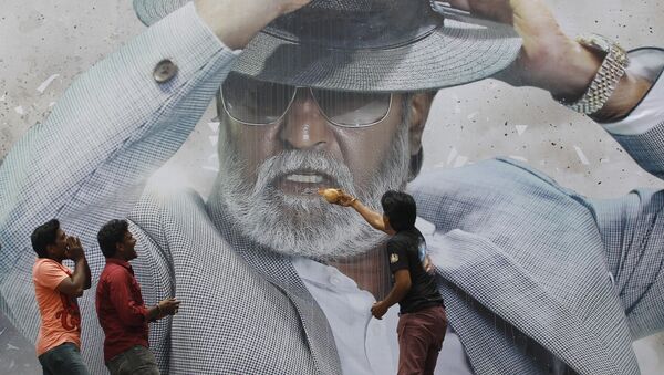 Fans of Indian superstar Rajinikanth offer prayers in front of his poster outside a cinema hall to celebrate the screening of “Kabali” in Chennai, India, Friday, July 22, 2016 - Sputnik International