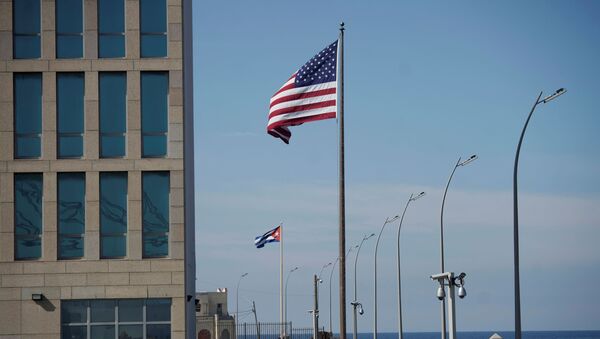 A view of Cuban and U.S. flags beside the U.S. Embassy in Havana, Cuba, December 15, 2020 - Sputnik International