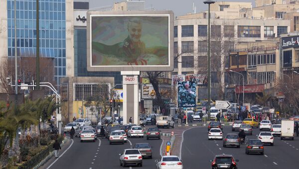A photo of senior Iranian military commander General Qassem Soleimani, is seen on a city giant screen on a street during the one year anniversary of his killing in a U.S. attack, in Tehran, Iran January 1, 2021. - Sputnik International