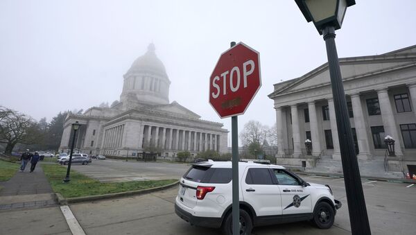 A Washington State Patrol vehicle patrols Thursday, Jan. 7, 2021, at the Capitol in Olympia, Wash., the day after supporters of President Donald Trump protested in Olympia against the counting of electoral votes in Washington, DC to affirm President-elect Joe Biden's victory. The Washington Legislature's 2021 session is scheduled to open on Monday, Jan. 11, 2021 - Sputnik International