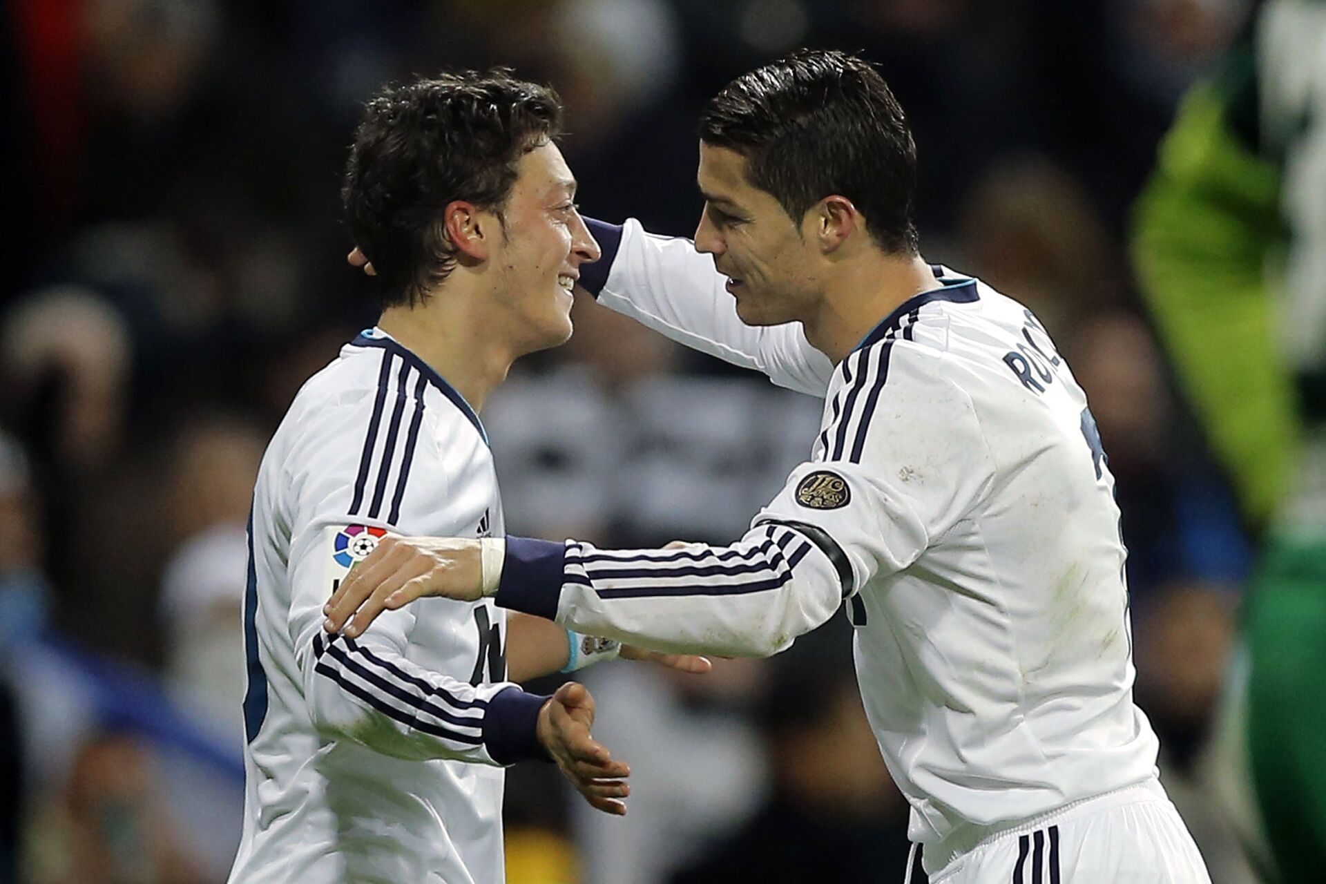 Real Madrid's Mesut Ozil from Germany, left, celebrates with Cristiano Ronaldo from Portugal after scoring a goal against Atletico de Madrid during a Spanish La Liga soccer match at the Santiago Bernabeu stadium in Madrid, Saturday, Dec. 1, 2012 - Sputnik International, 1920, 07.09.2021