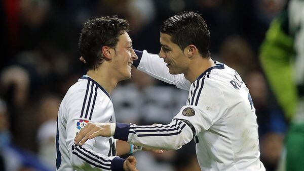 Real Madrid's Mesut Ozil from Germany, left, celebrates with Cristiano Ronaldo from Portugal after scoring a goal against Atletico de Madrid during a Spanish La Liga football match at the Santiago Bernabeu stadium in Madrid, Saturday, 1 December 2012. - Sputnik International