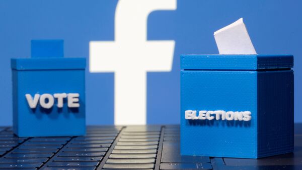 3D printed ballot boxes are seen in front of a displayed Facebook logo in this illustration taken November 4, 2020. REUTERS/Dado Ruvic/Illustration/File Photo - Sputnik International