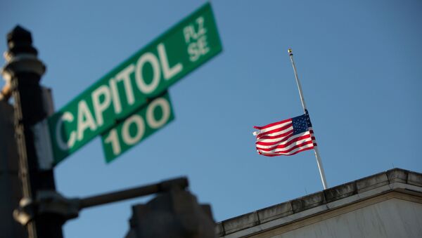 A flag flies at half-mast at the Longworth House Office Building across from the U.S. Capitol building to honor slain Capitol Police Officer Brian Sicknick on Capitol Hill in Washington, U.S., January 10, 2021 - Sputnik International