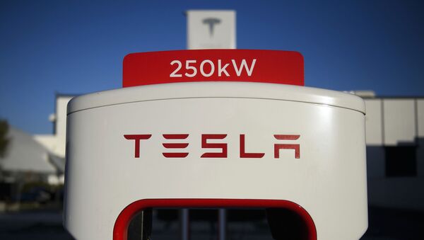 (FILES) In this file photo a Tesla logo is seen on a 250kW electric vehicle charging station at the Tesla Inc. supercharger station on January 4, 2021 in Hawthorne, California. - Sputnik International