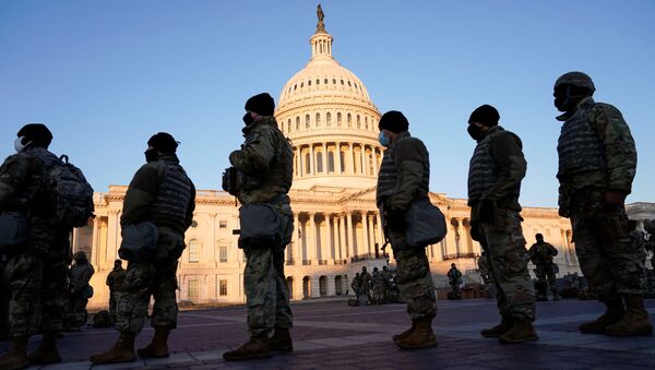 Members of the National Guard are given weapons before Democrats begin debating one article of impeachment against U.S. President Donald Trump at the U.S. Capitol, in Washington, U.S., January 13, 2021 - Sputnik International