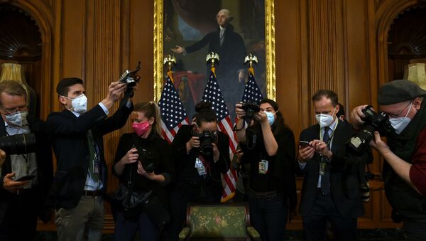 Photographers take pictures of the article of impeachment against US President Donald Trump during an engrossment ceremony after the US House of Representatives voted to impeach him at the US Capitol, 13 January 2021, in Washington, DC. - Sputnik International