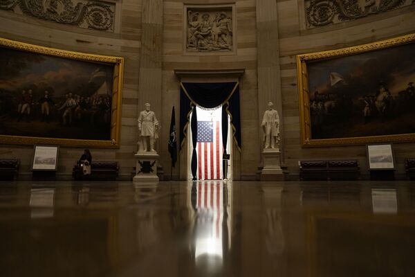 Light shines on an American flag as seen from the Capitol Rotunda in Washington, Wednesday, 13 January 2021.  - Sputnik International