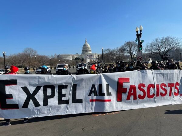 Protesters hold a banner outside the US Capitol.  - Sputnik International