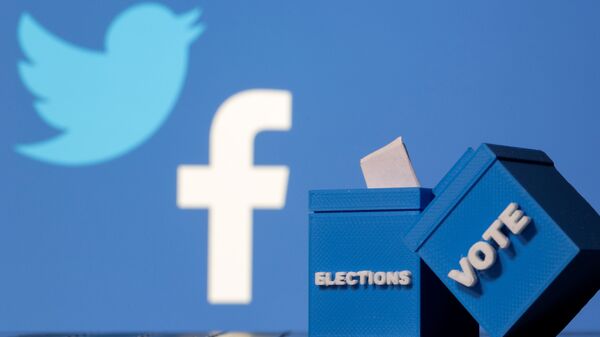 3D-printed ballot boxes are seen in front of displayed Facebook and Twitter logos in this illustration taken November 4, 2020 - Sputnik International