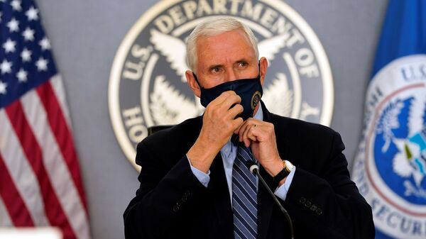 Vice President Mike Pence adjusts his face mask as he listens during a briefing about the upcoming presidential inauguration of President-elect Joe Biden and Vice President-elect Kamala Harris, at FEMA headquarters, January 14, 2021, in Washington - Sputnik International