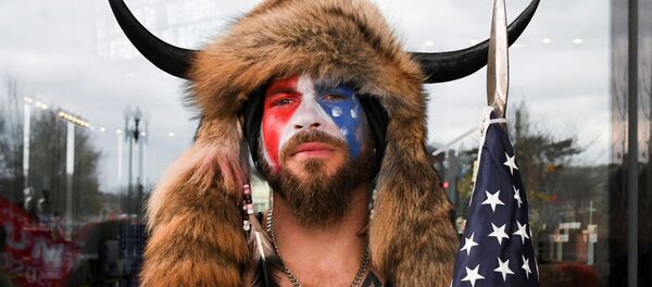 Jacob Anthony Chansley, also known as Jake Angeli, of Arizona, poses with his face painted in the colors of the US flag as supporters of US President Donald Trump gather in Washington, US, 6 January 2021 Jacob Anthony Chansley, also known as Jake Angeli, of Arizona, poses with his face painted in the colors of the US flag as supporters of US President Donald Trump gather in Washington, US, 6 January 2021 - Sputnik International
