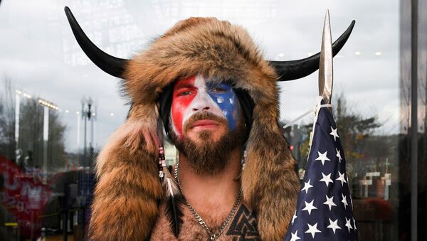  Jacob Anthony Chansley, also known as Jake Angeli, of Arizona, poses with his face painted in the colors of the US flag as supporters of US  President Donald Trump gather in Washington, US, 6 January 2021 - Sputnik International