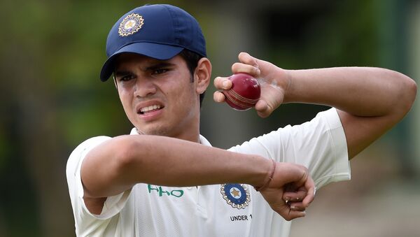 Indian under-19 cricketer Arjun Tendulkar, son of the Indian former cricket superstar Sachin Tendulkar, holds a ball during a practice session before the start of the warm-up match between the Indian under-19 and Sri Lankan under-19 teams at the Nondescripts Cricket Club (NCC) Cricket Stadium in Colombo on July 13, 2018 - Sputnik International