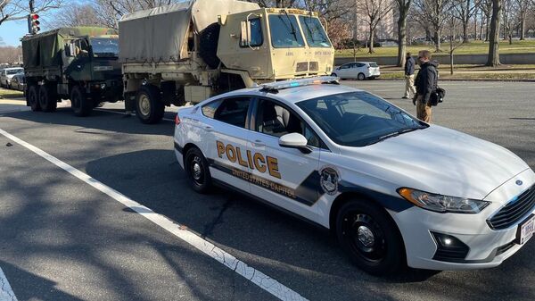 Military vehicles and a police car parked not far from the US Capitol building - Sputnik International