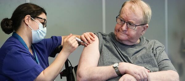 Svein Andersen, 67 years-old resident of 'Ellingsrud home' and first in Norway to receive the vaccine is given the Pfizer-Biontech Covid-19 corona virus vaccine by Nurse Maria Golding in Oslo, Norway, on December 27, 2020. - Sputnik International