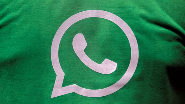 A logo of WhatsApp is pictured on a T-shirt worn by a WhatsApp-Reliance Jio representative during a drive by the two companies to educate users - Sputnik International