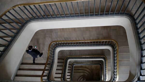 An official walks down the stairs prior to the visit of French President Emmanuel Macron at the Crisis and Support Center in the French Foreign Affairs ministry to give support and repatriation to French citizens abroad at Quai D'Orsay in Paris, Friday, April 3, 2020. Macron paid tribute to those who helped more than 130,000 French citizens to return to France since mid-March as countries across the world were closing their borders amid the coronavirus crisis. The new coronavirus causes mild or moderate symptoms for most people, but for some, especially older adults and people with existing health problems, it can cause more severe illness or death. - Sputnik International