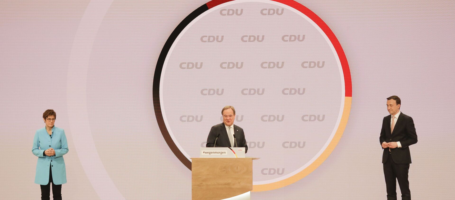 The new elected Christian Democratic Union, CDU, party chairman Armin Laschet, center, speaks as outgoing chairwoman Annegret Kramp-Karrenbauer, left, and Secretary General Paul Ziemiak listen, after the voting at a digital party convention in Berlin, Germany, Saturday, Jan. 16, 2021. The party of German Chancellor Angela Merkel decided on a successor for the outgoing chairwoman Annegret Kramp-Karrenbauer, left, at the convention. - Sputnik International, 1920, 16.01.2021