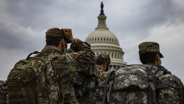 National Guard soldiers prepare for their guard shifts at the U.S. Capitol building on January 15, 2021 in Washington, DC. Due to security threats following last week's storming of the U.S. Capitol by a pro-Trump mob, law enforcement agencies have increased security measures along the National Mall and much of downtown Washington, DC, essentially closing down the Mall a week ahead of President-elect Joe Biden's inauguration. - Sputnik International