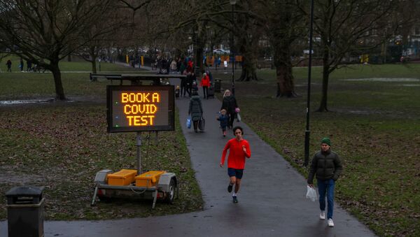 A sign urging local residents to book a COVID test is seen on Eel Brook Common as Britain continued its third COVID-19 lockdown in Fulham, London, Britain, January 16, 2021.  - Sputnik International
