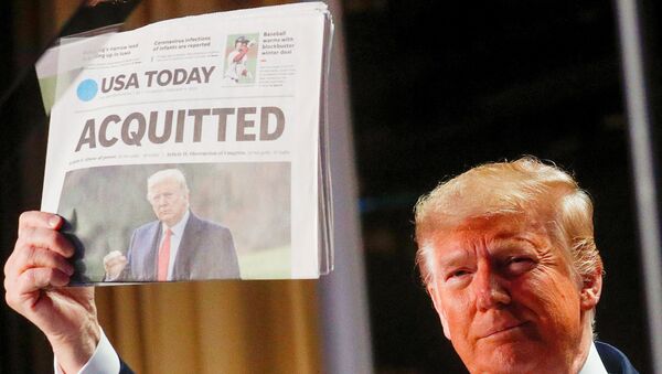 U.S. President Donald Trump holds up a copy of USA Today's front page showing news of his acquittal in his Senate impeachment trial, as he arrives to address the National Prayer Breakfast in Washington, U.S., February 6, 2020 - Sputnik International